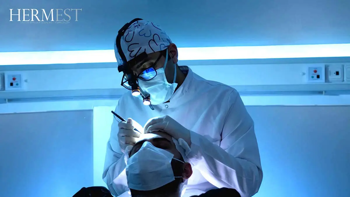Dr. Ahmet Murat performing a hair transplant procedure at Hermest Hair Clinic